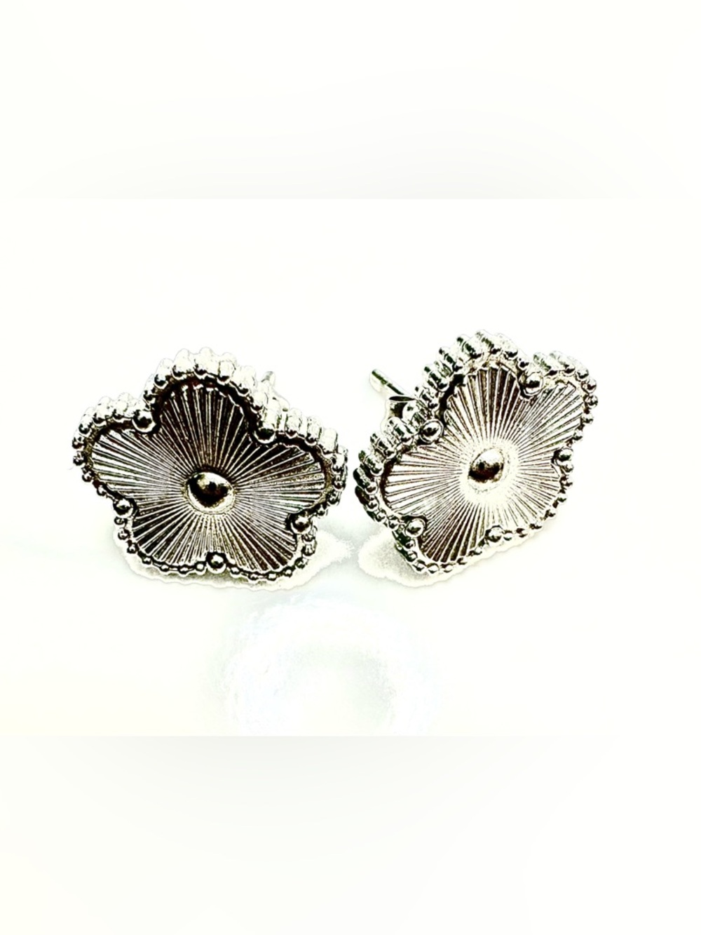 Silver tone clover earrings with 18k gold filled over stainless steel.